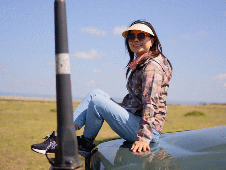 Traveler relaxing on a safari vehicle during an all inclusive safari adventure in Africa.