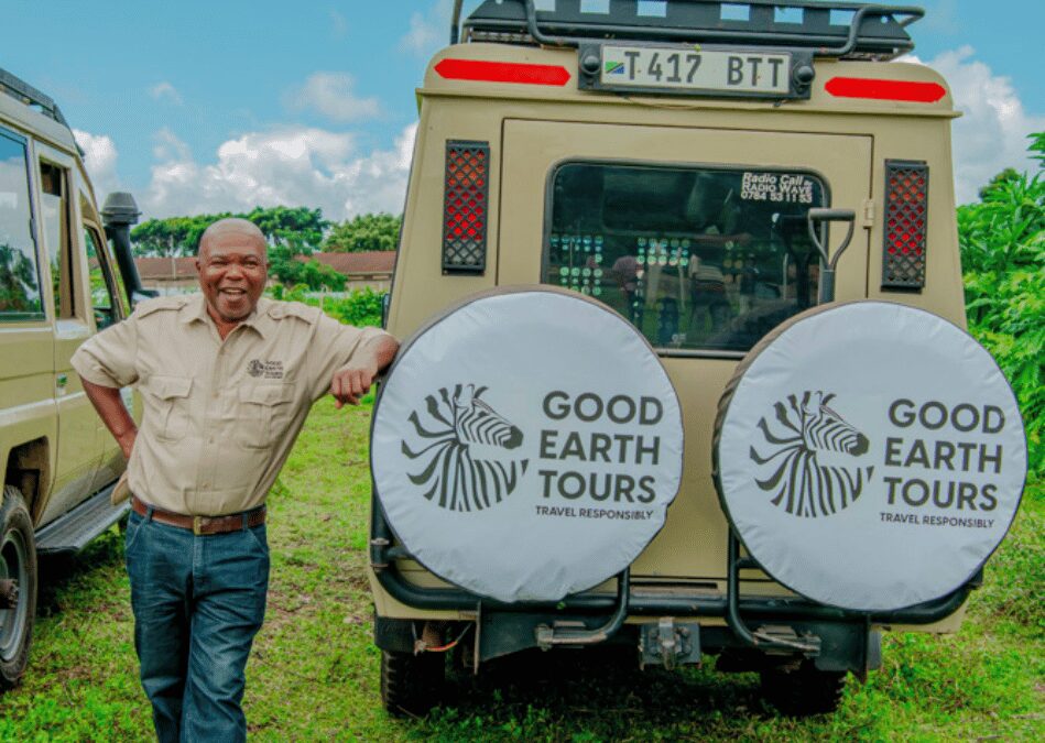 Good earth tours guide standing beside a 4*4 land cruiser