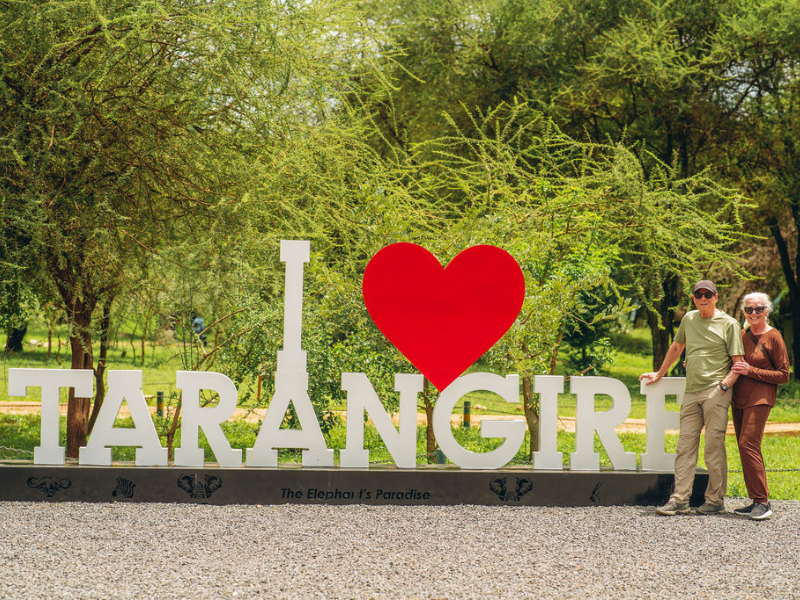 How Many Days Do You Need for Safari? A Realistic Guide to Planning the Right Length 3 Travelers posing at Tarangire National Park entrance sign in Tanzania