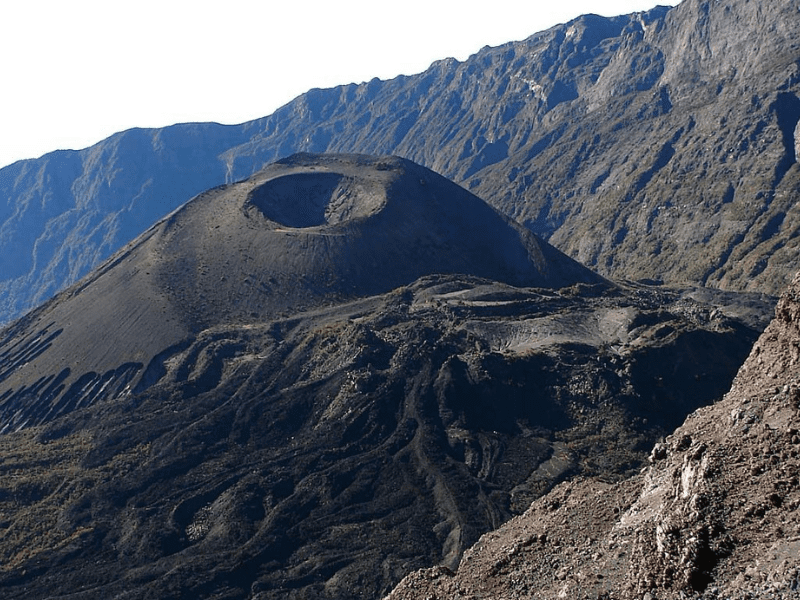 Ash cone crater within Mt Meru’s caldera, surrounded by dramatic volcanic ridges and rocky terrain in Arusha National Park.