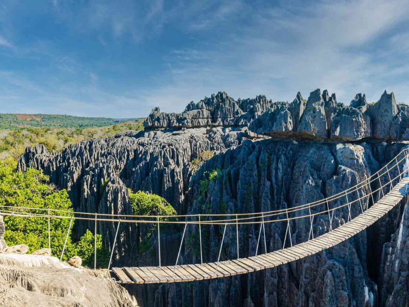 A hanging bridge over the sharp limestone formations of Tsingy de Bemaraha National Park in Madagascar, a UNESCO World Heritage site.