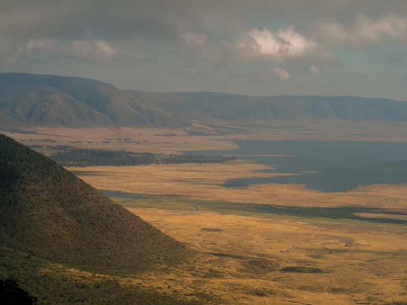 Ngorongoro Crater Tanzania: Facts, History, and What to Expect 2 Expansive view over rolling green plains and valley shadows, highlighting the scale of the caldera