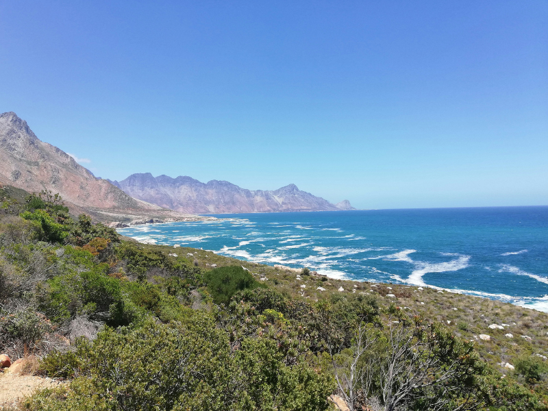 Coastal mountain and ocean view in South Africa, with waves breaking along a rugged shoreline