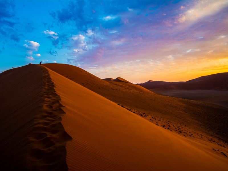 Red sand dunes in Namibia at sunset near Sossusvlei desert.