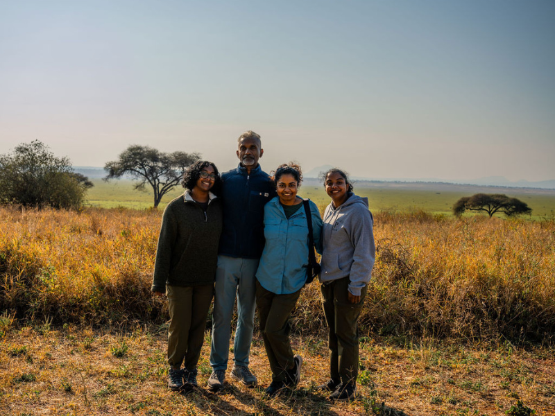 Family enjoying a guided safari experience in the African savannah.