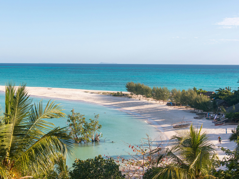 The Top Places to Visit in Madagascar and Travel Tips 4 Tropical beach with turquoise water, white sand, and palm trees, capturing the island’s laid-back coastal beauty.