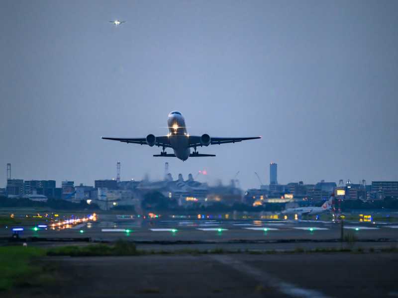 How to Get to Your African Safari Without Flying Through the Middle East 1 Commercial airplane taking off from a runway at dusk, representing direct flight routes from the US and Europe to African safari destinations