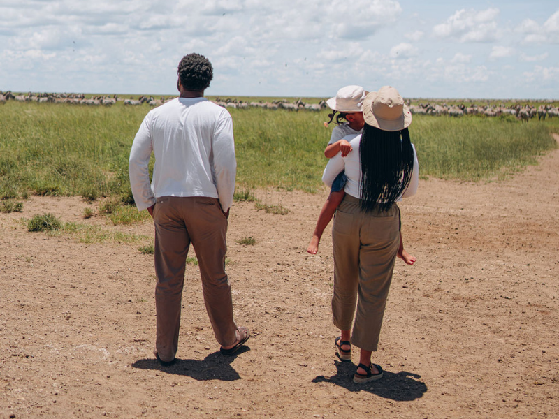 A family of three enjoying their time on a safari 