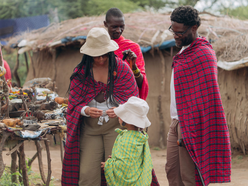 Family visiting a Maasai village during an African family safari, creating meaningful cultural experiences alongside wildlife adventures.